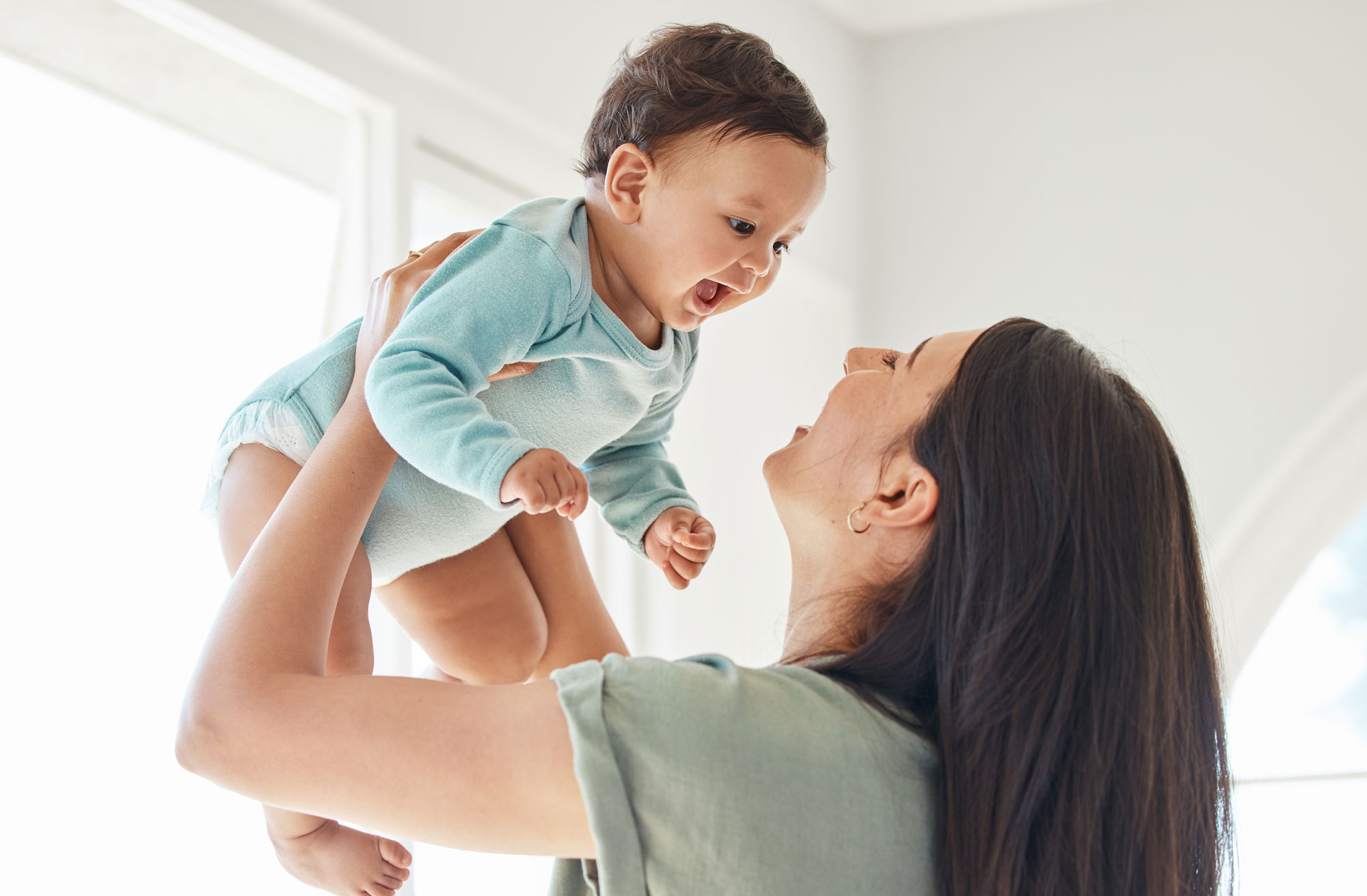 Mother holding up her toddler during the most transformative years of childhood.