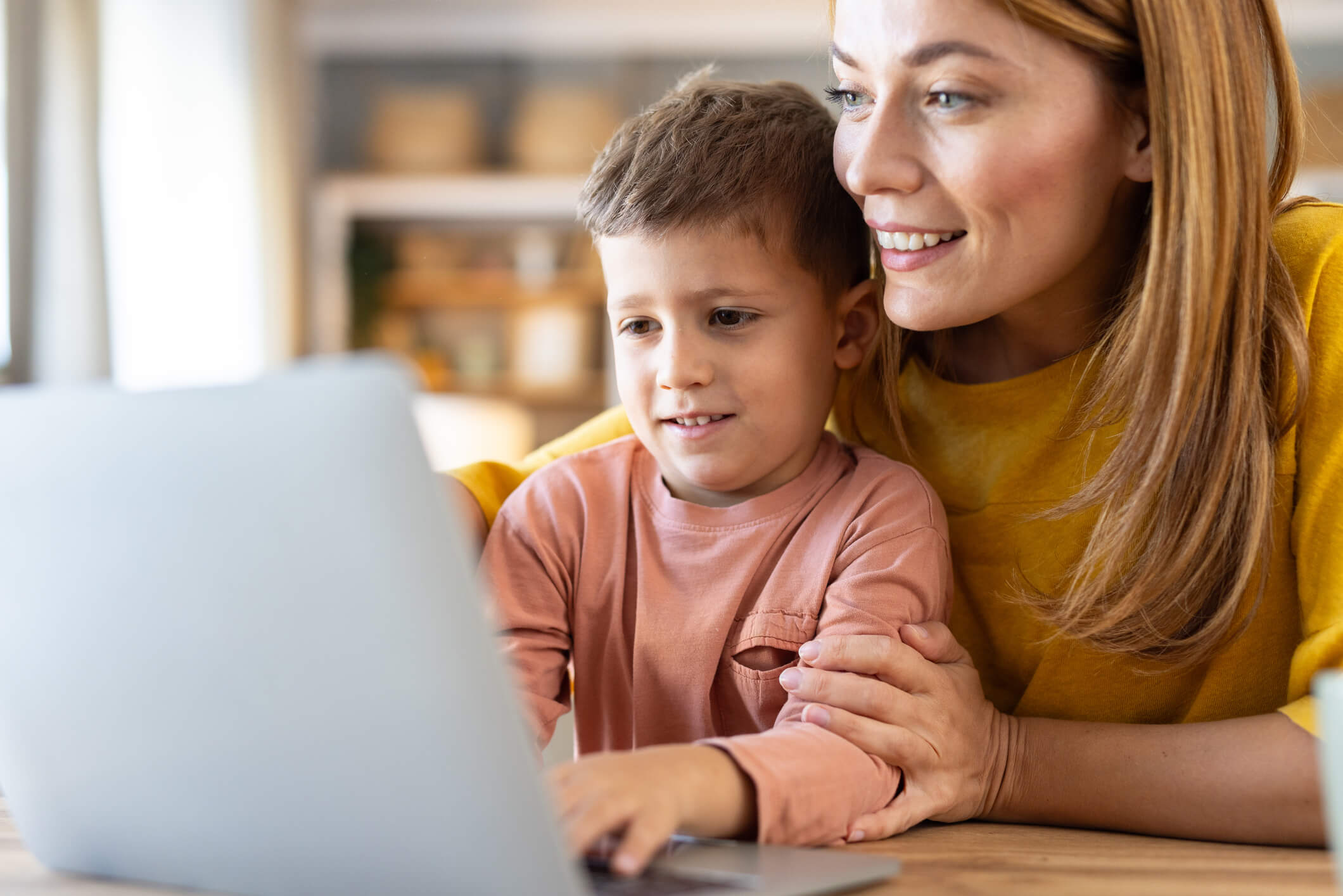 Child and Mother at computer smiling