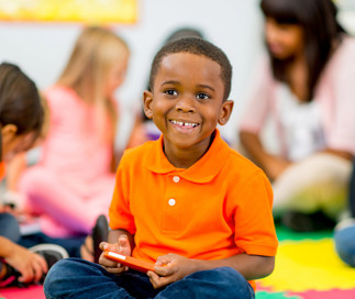 pre-k student learning and having fun with his friends at school