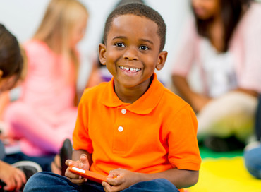 pre-k student learning and having fun with his friends at school