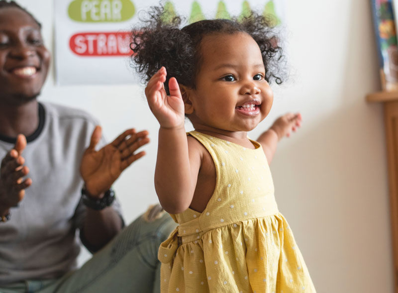 Early preschool aged girl in a yellow dress in a daycare classroom