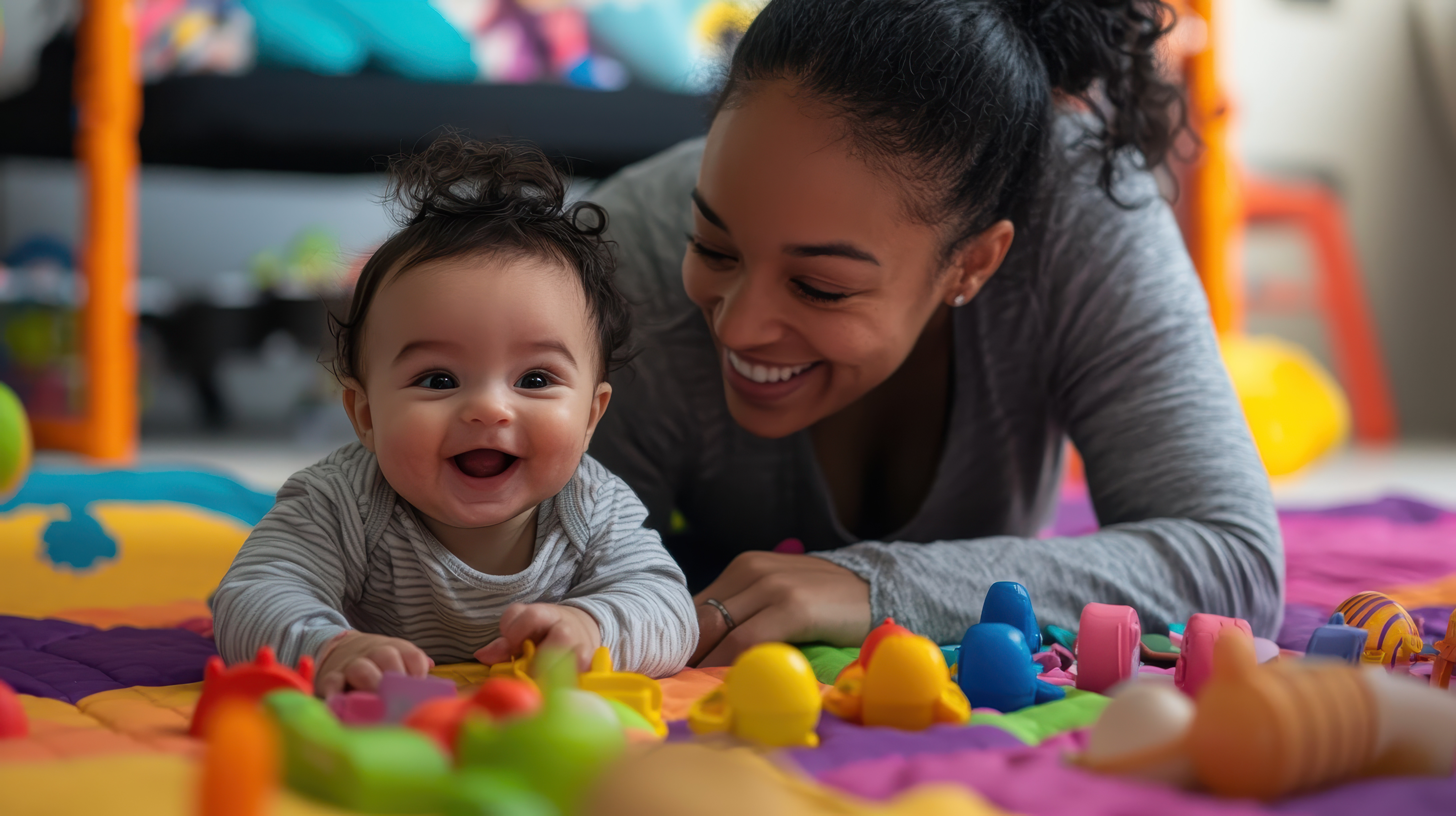 baby and mom on the ground with colorful toys