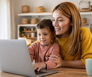 Mother and child sitting at a computer learning how to enroll at Foundations Early Learning Center